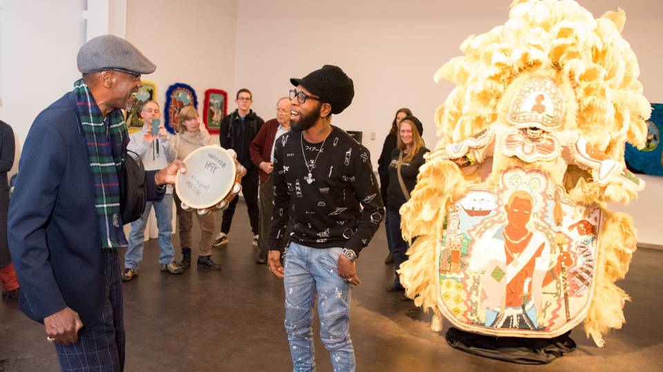 Big Chief Darryl Montana and Big Chief Demond Melancon dancing in front of ceremonial suit
