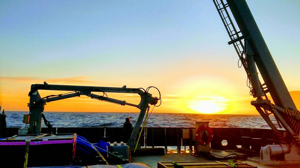 Sunset on the ocean from a research boat