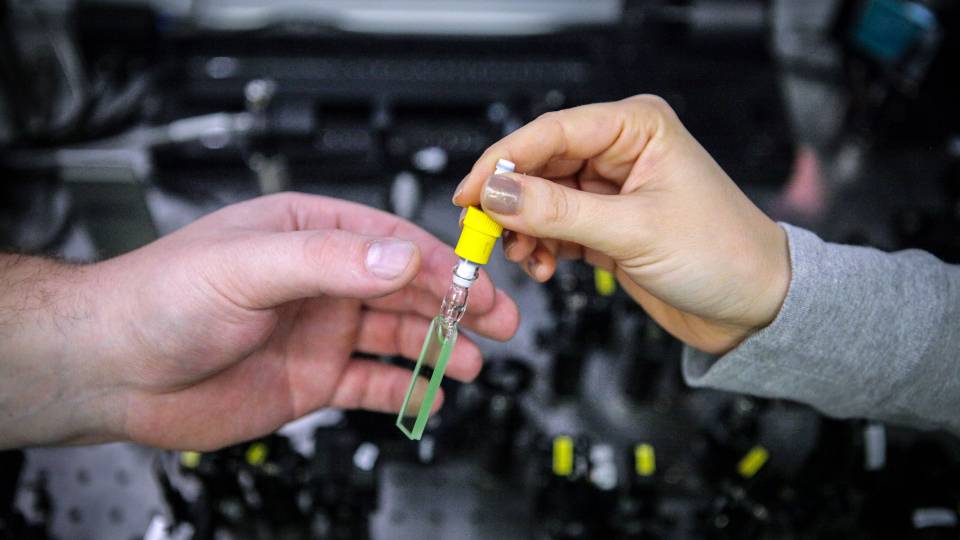 One researcher hands a sample to another