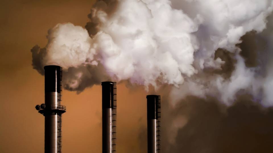 3 smokestacks belching white smoke