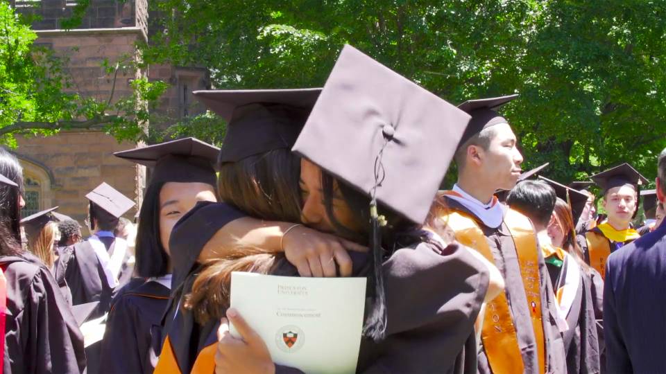 Graduating students hug