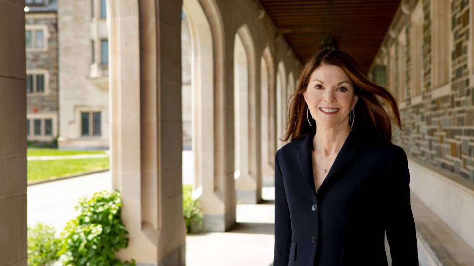 Sandie Bermann under arches of Whitman College