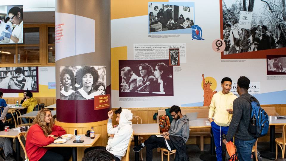 Students in front of an exhibit of archival photos and historical information at Frist