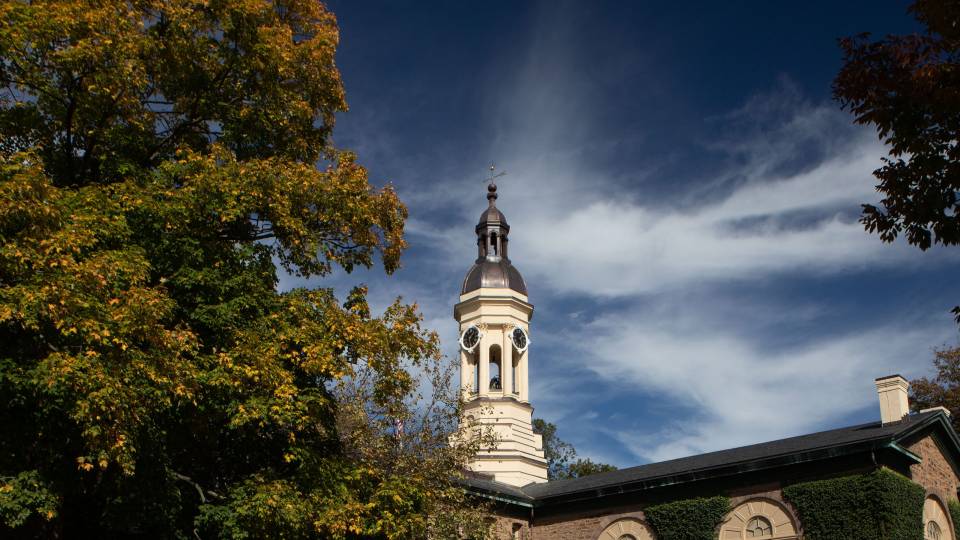 Nassau Hall with white clouds and blue sky behind