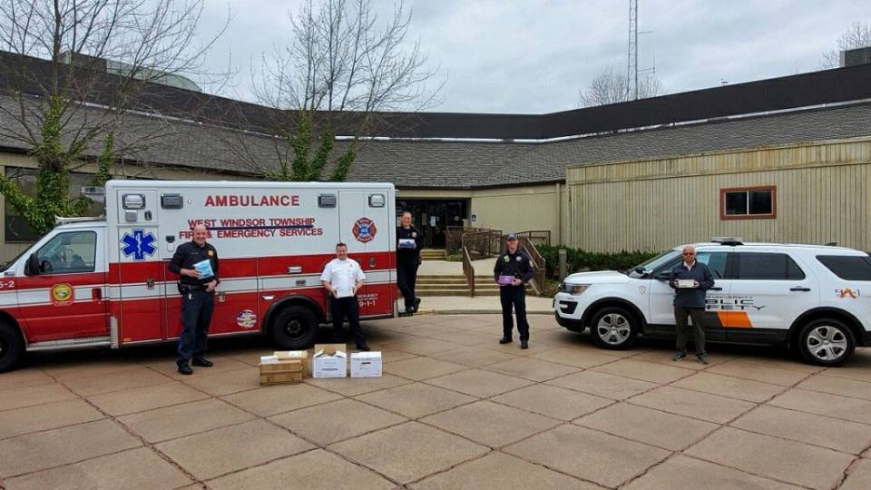 Staff pose with emergency vehicles and supplies in West Windsor