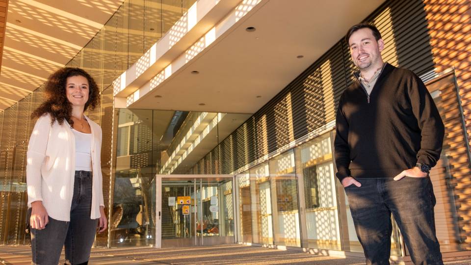 Alexis Cowan and Michael Neinast at the entrance of the Icahn building