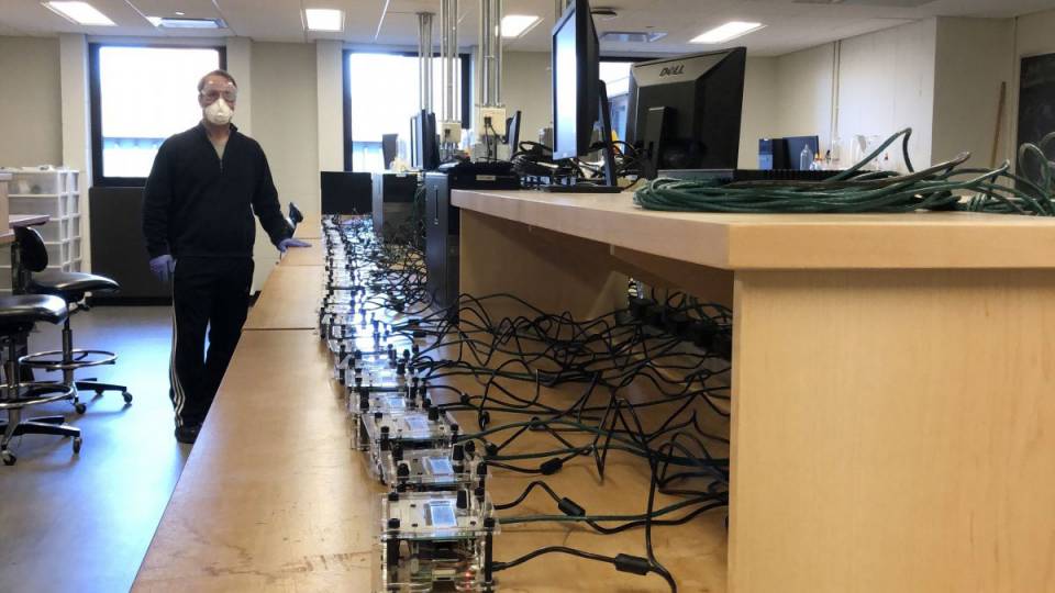 A professor and a row of machines