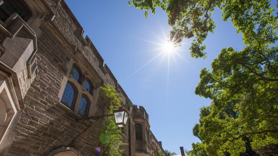 sun overhead with roofline of residence