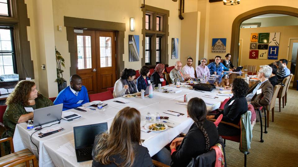 Faculty members meeting around a long table