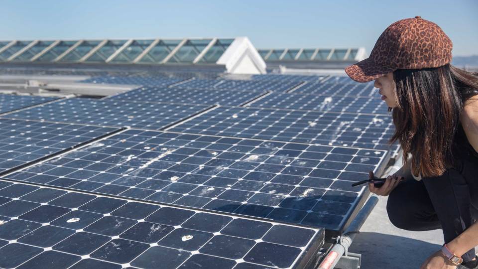 A student examines solar panels