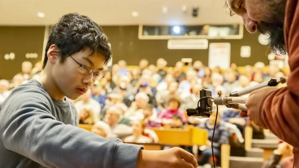 A student takes part in a magnet experiment