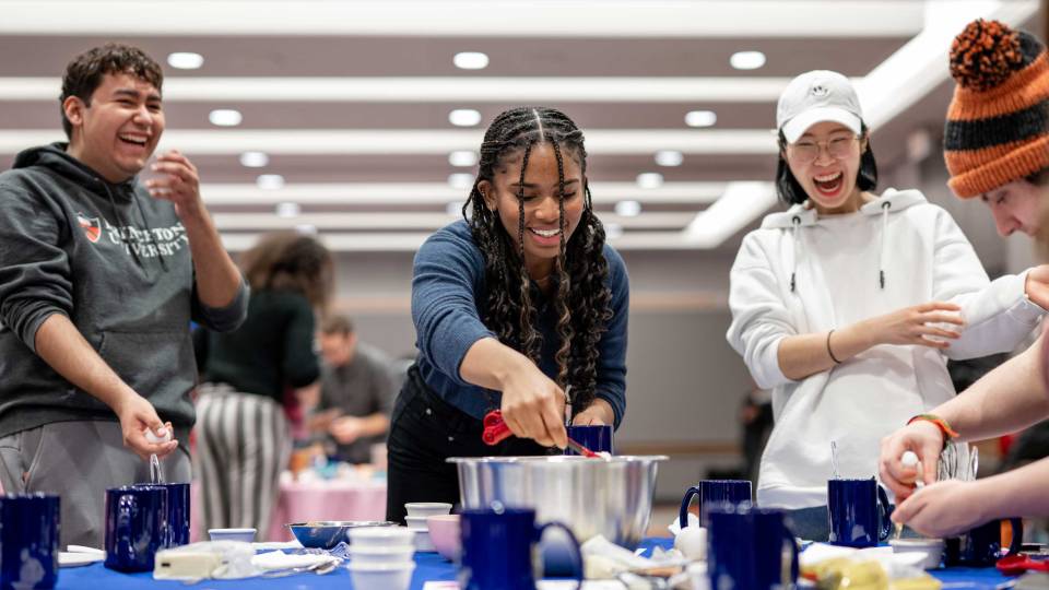 Students laugh as they participate in a TikTok cooking lesson