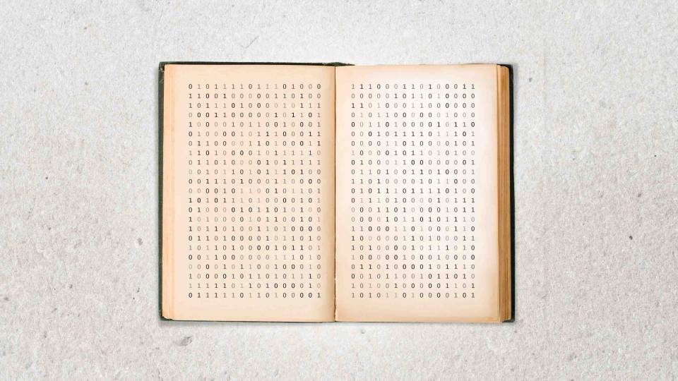 Opened book containing written binary code