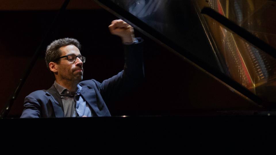 Bliss playing a grand piano