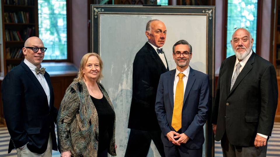 Jose Ferrer's family and the artist pose next to the portrait
