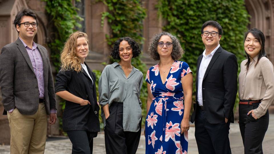 Six scholars standing shoulder to shoulder