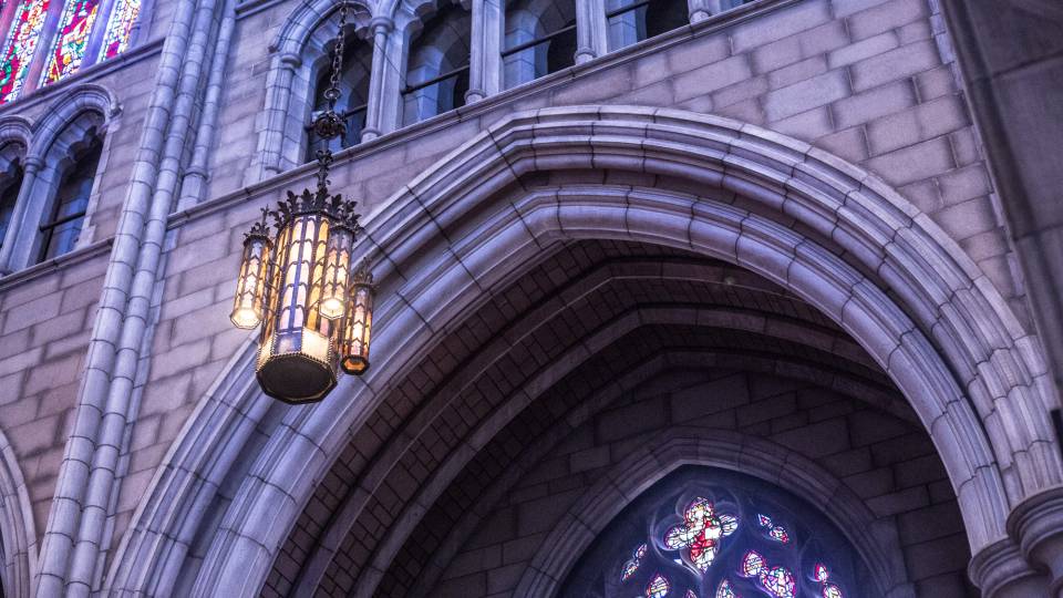 A lit chandelier inside the Princeton University Chapel