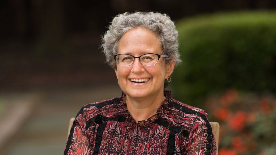 Melissa Lane smiling in a garden