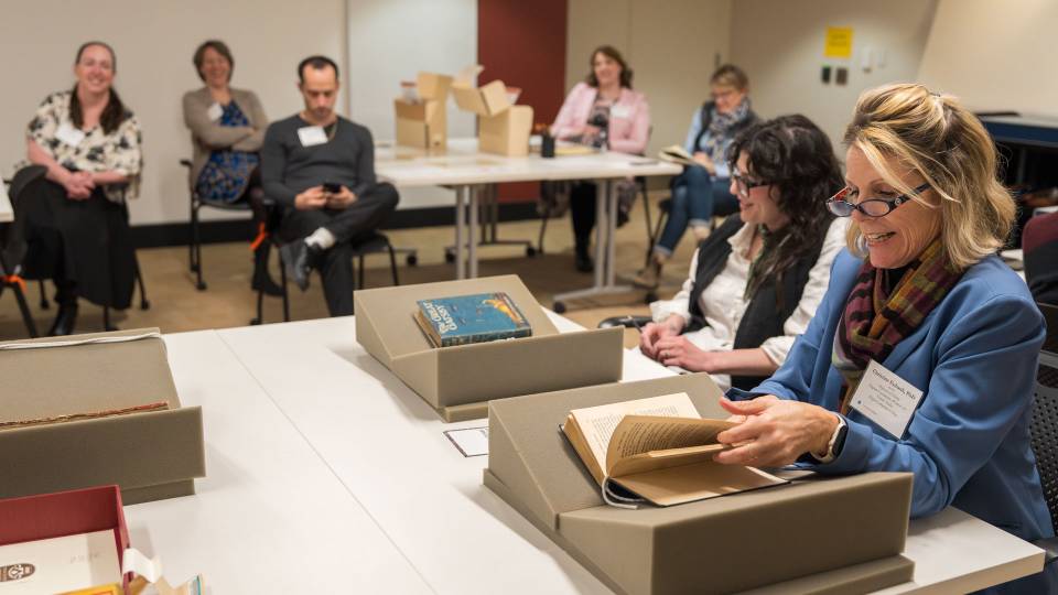 Educators looking at books in Princeton University Library's Special Collections room.