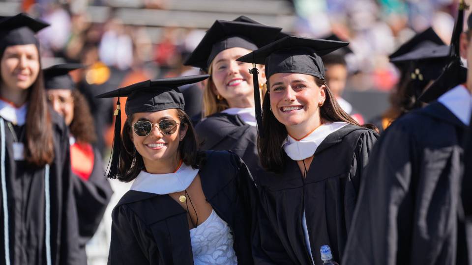 Smiling graduates in their caps and gowns