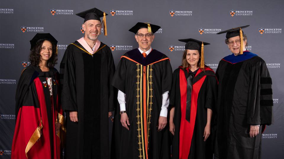 Four faculty members with President Eisgruber