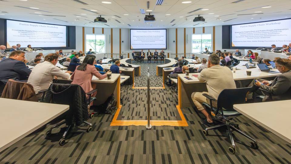 Experts attend a presentation in a packed Rutgers classroom during the fusion supply chain conference..