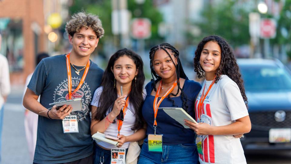 A group of student journalists pose during a person-on-the-street reporting assignment