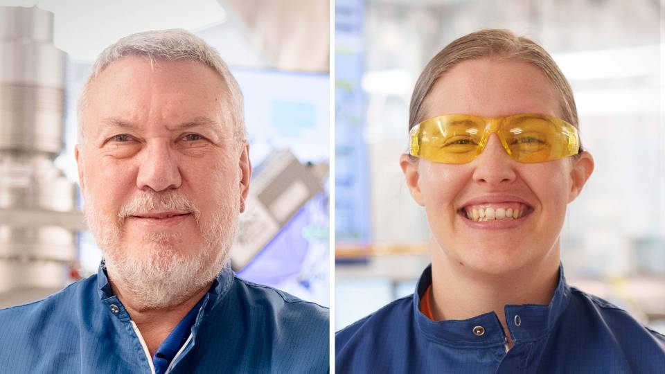 A man and a woman smile in protective equipment.
