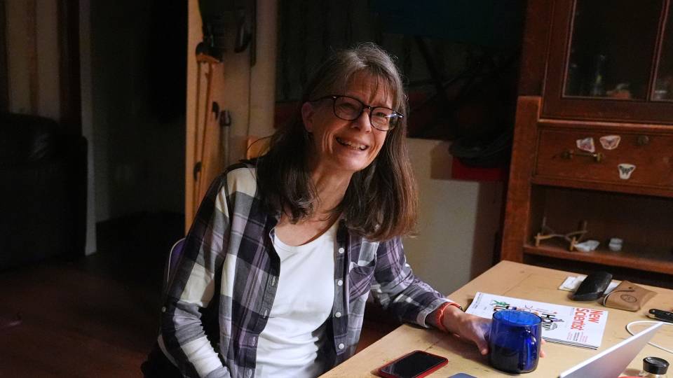 Mary Brunkow working on a laptop at her desk