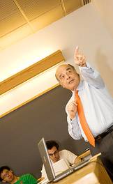 Mahmoud gestures to a projected slide