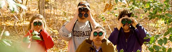 students looking through binoculars