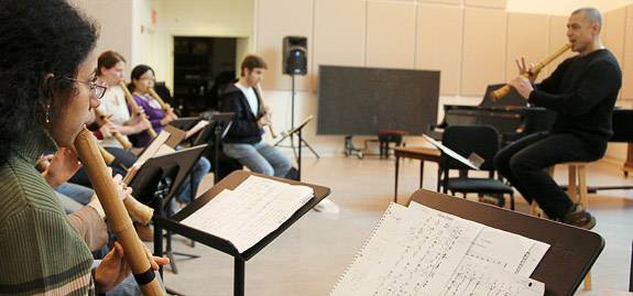 class playing flutes together