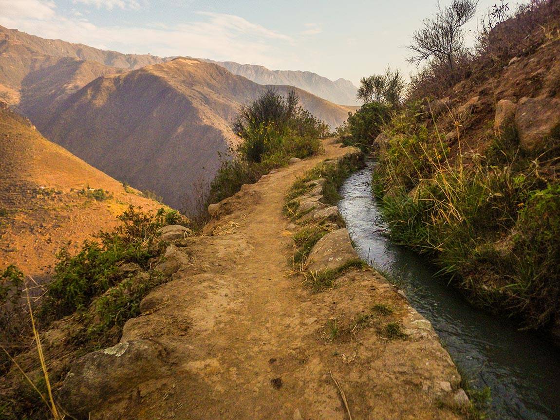 Engineers Without Borders students: In La Pitajaya, residents had dug a trench to supply water many years ago, but mining in the region had contaminated the canal. The EWB team buried a new pipeline in the thin strip of land between the canal and the cliff.