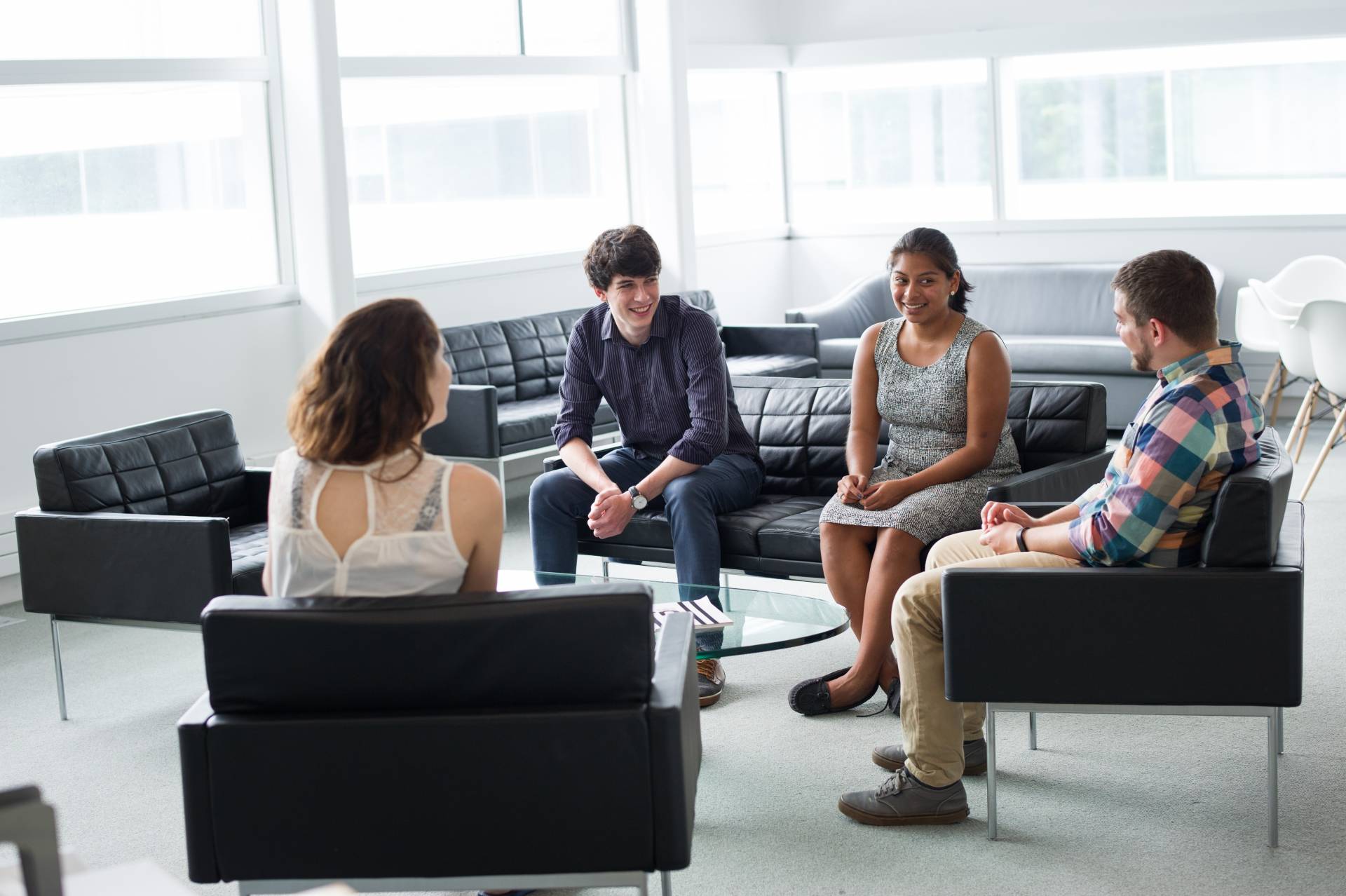 Graduate students sitting indoors and talking