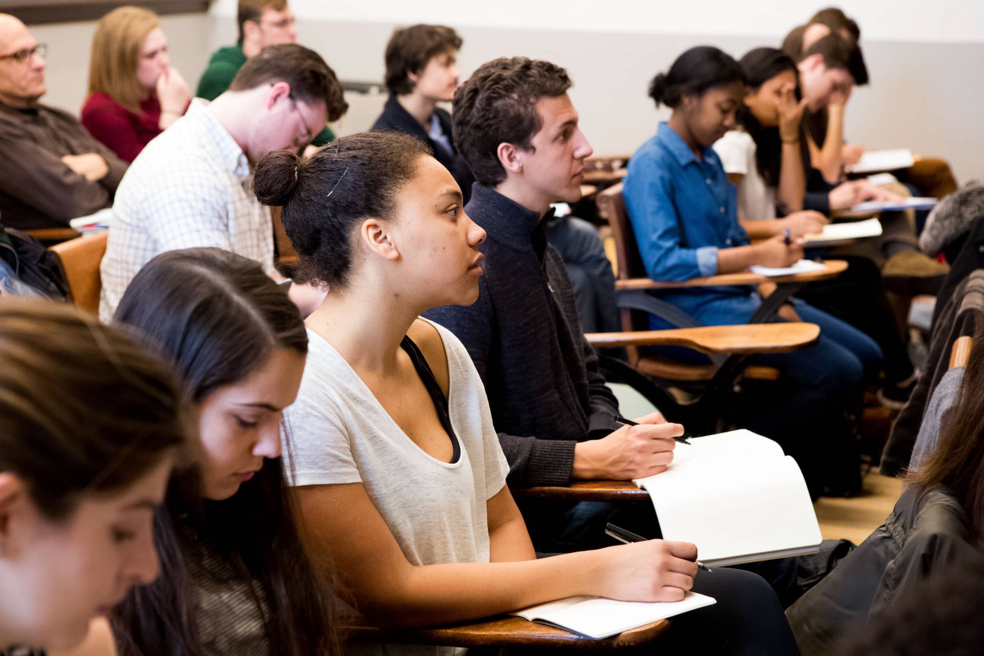 Students look forward while taking notes in a classroom