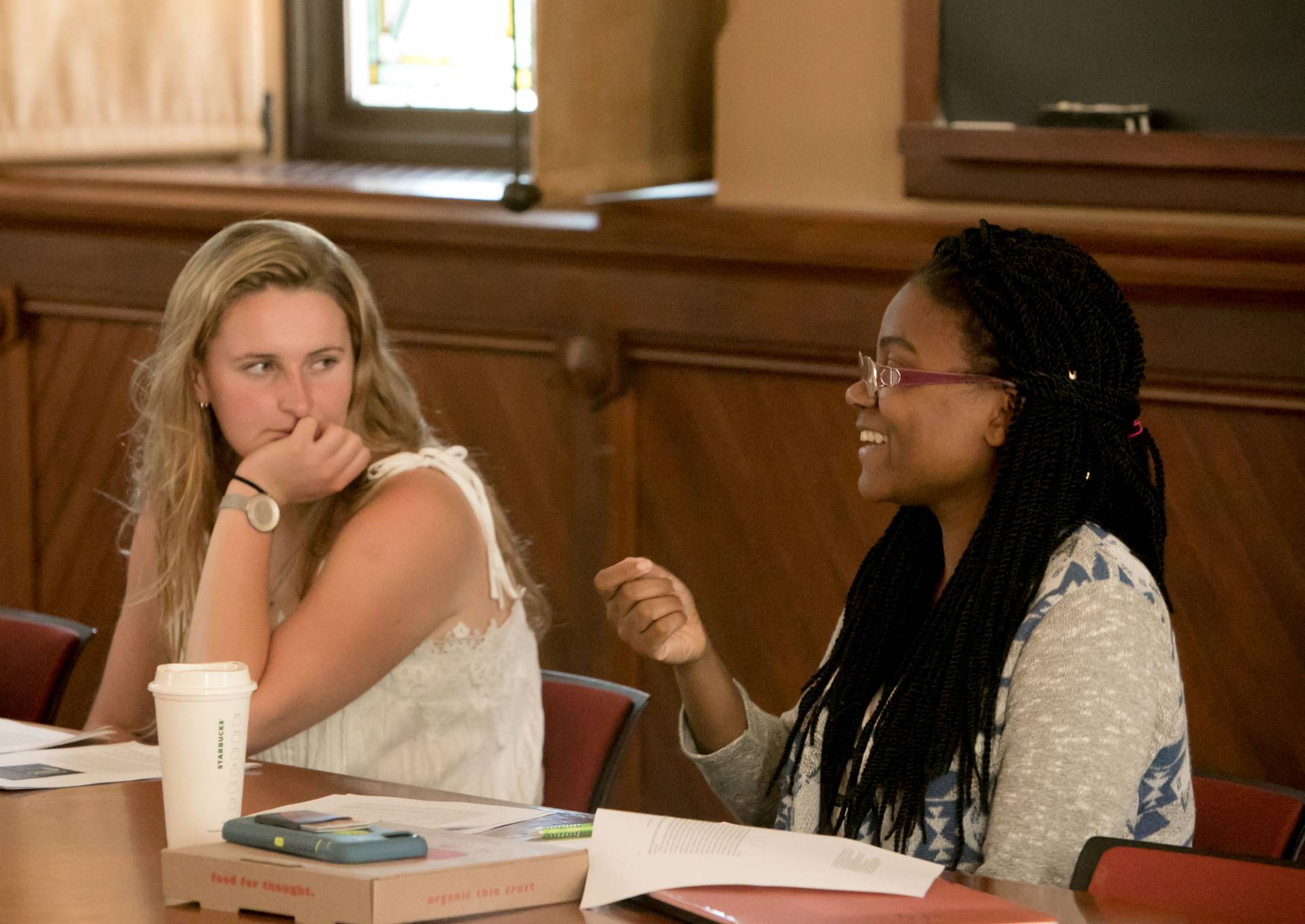 Junior Myesha Jemison (right) and sophomore Charlotte Valentine in the class, "White Hunters, Black Poachers" being taught by Jacob Dlamini 
