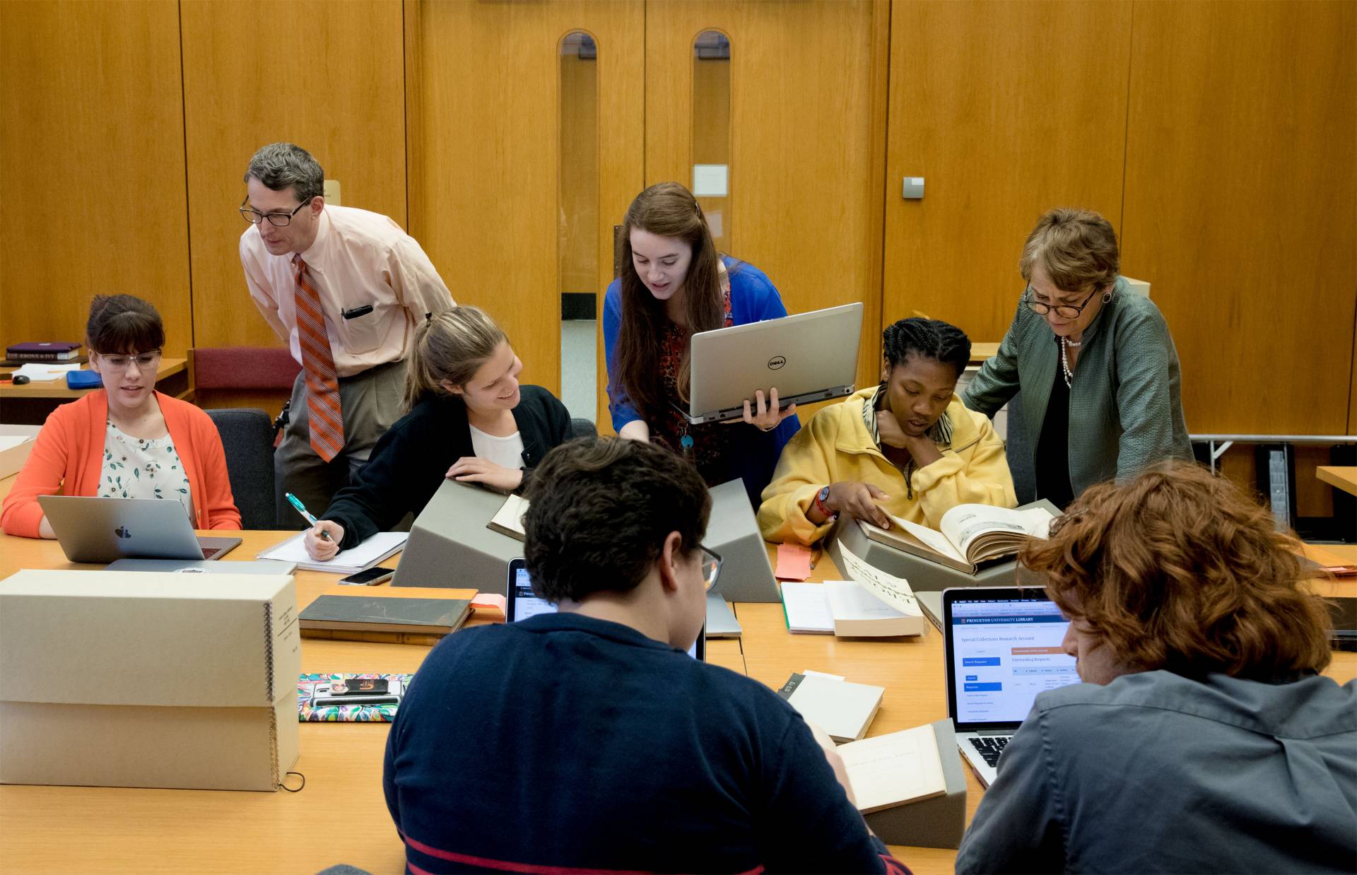 University Archivist Dan Linke with students and Professor Martha Sandweiss looking at archive materials