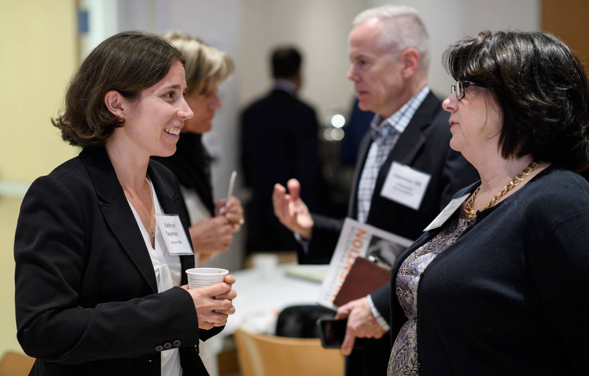 Two participants talk at biomedicine conference