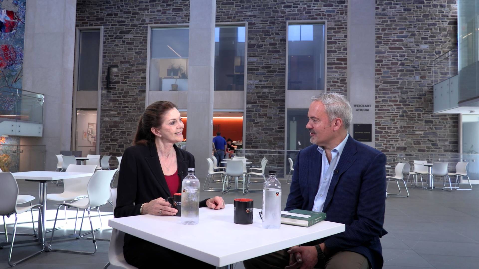 Sandra Bermann and Stephen Macedo talk at a table