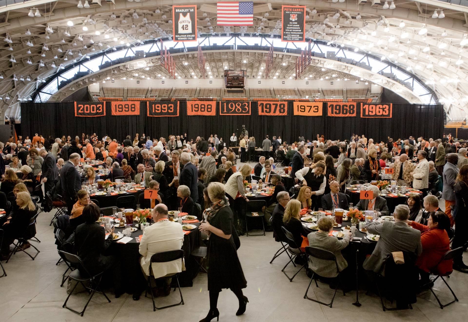 Crowd sitting at tables in Jadwyn Gym during Alumni Day