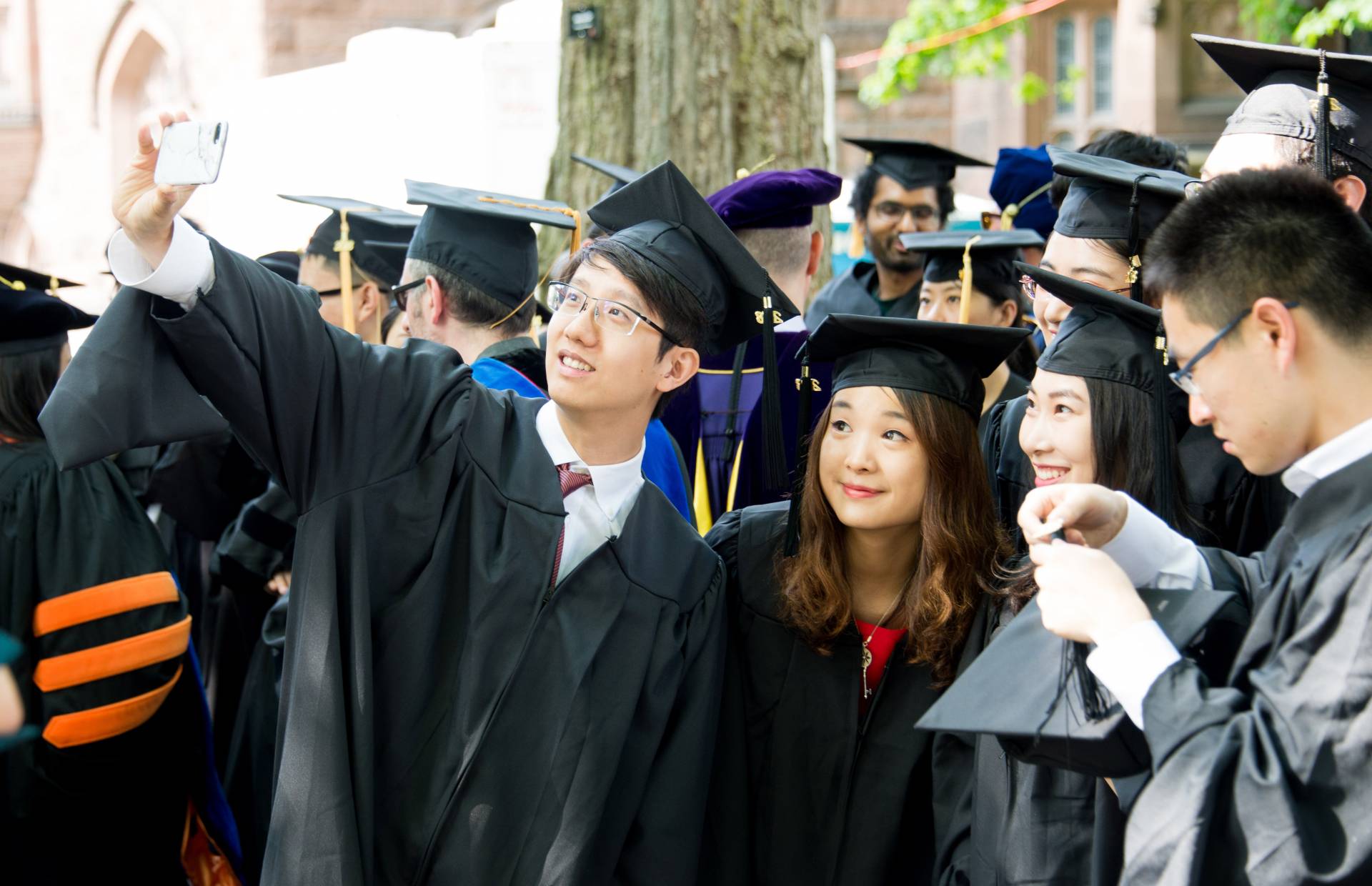 Students taking a selfie before Hooding Ceremony