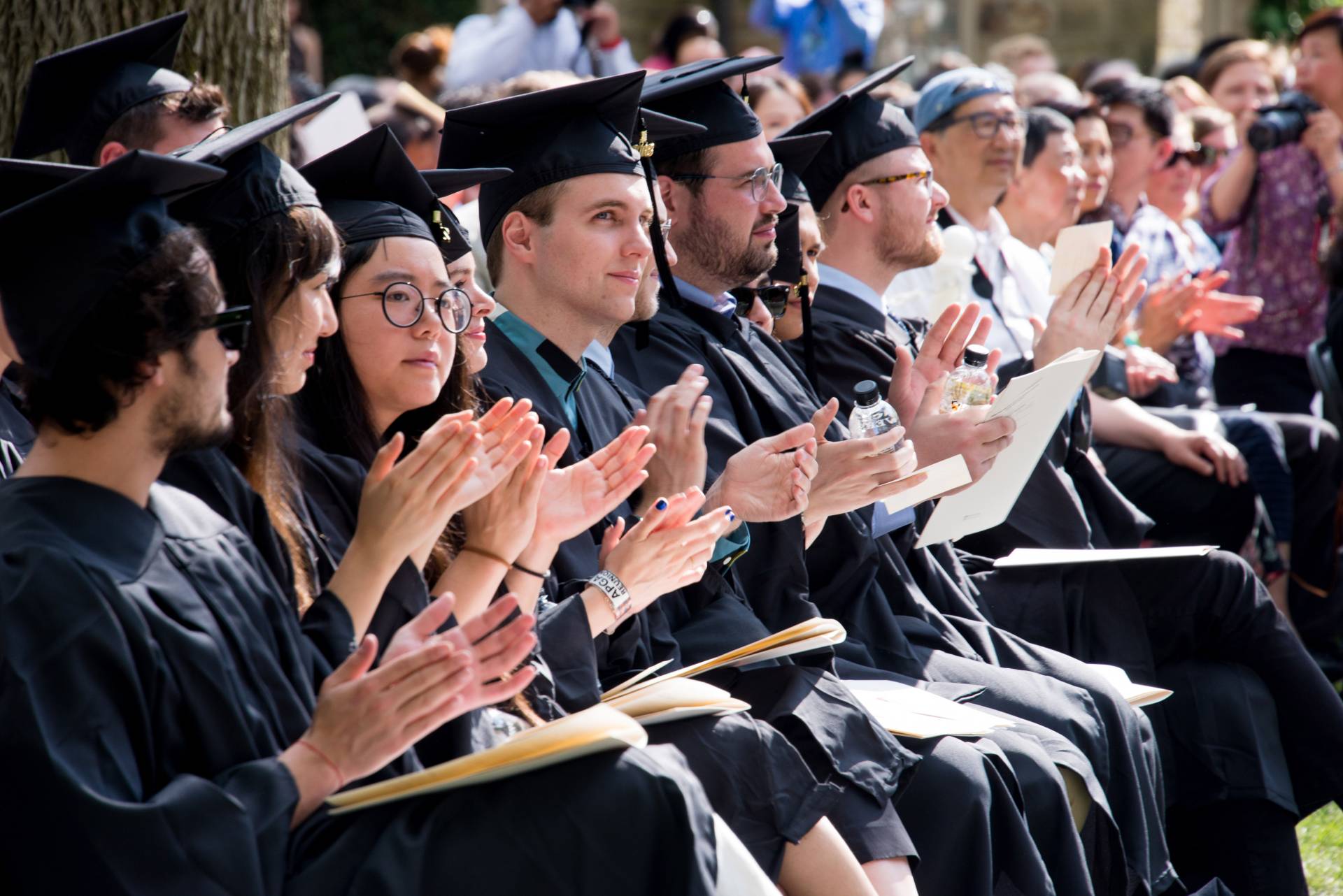Grad students sitting at Hooding Ceremony
