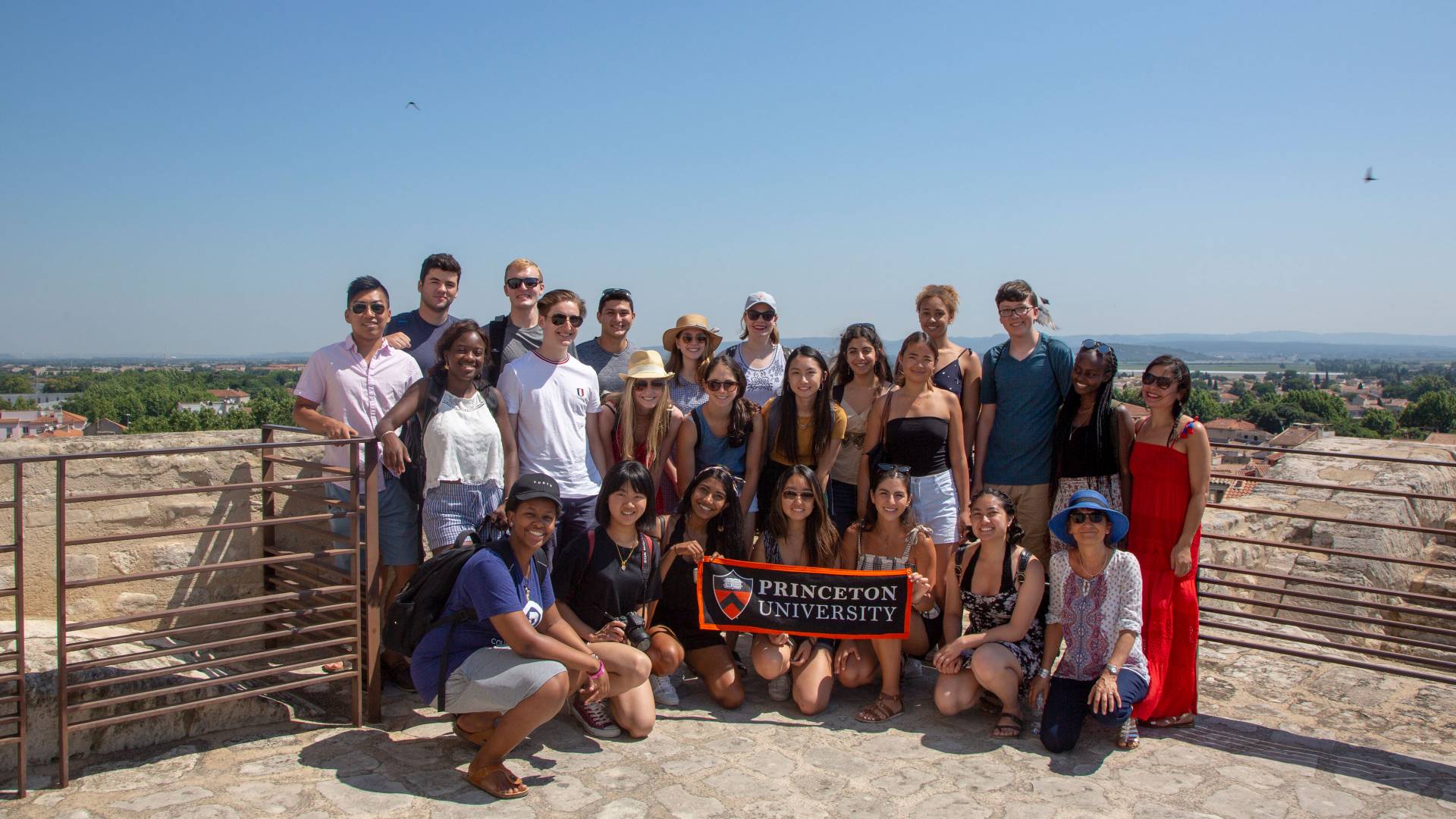 Students and faculty pose with Princeton University banner in France