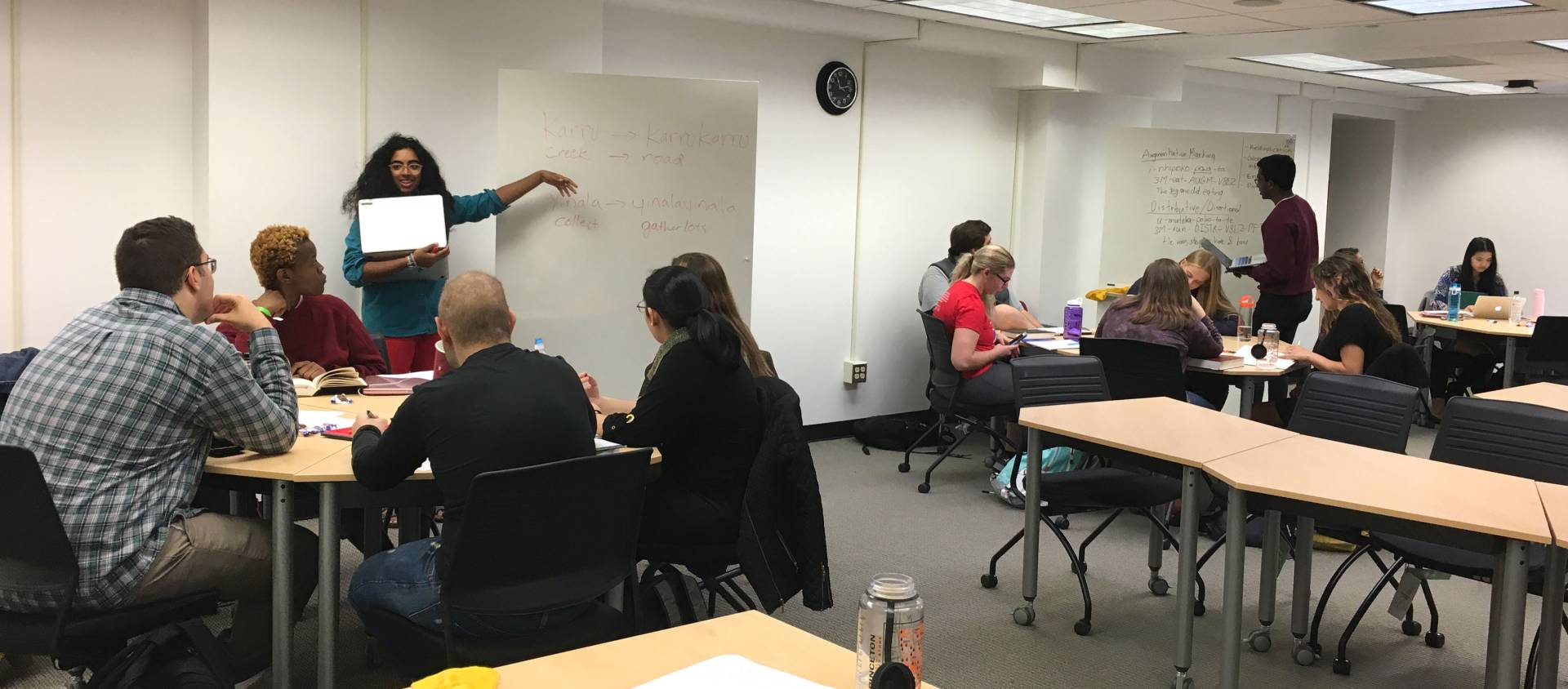 Students presenting to other students in large classroom