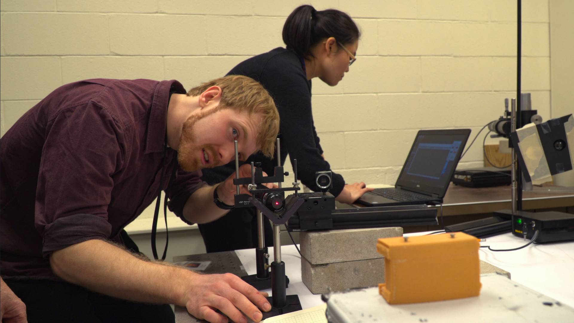 Brian Kraus working in plasma physics lab with Lan Gao