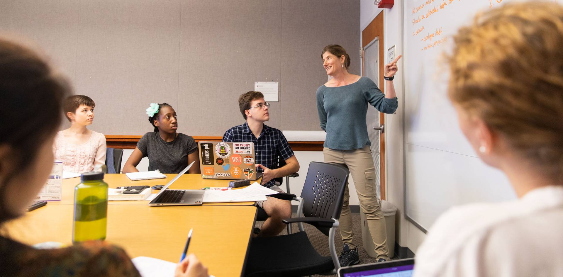 Shana Webber at whiteboard teaching a class