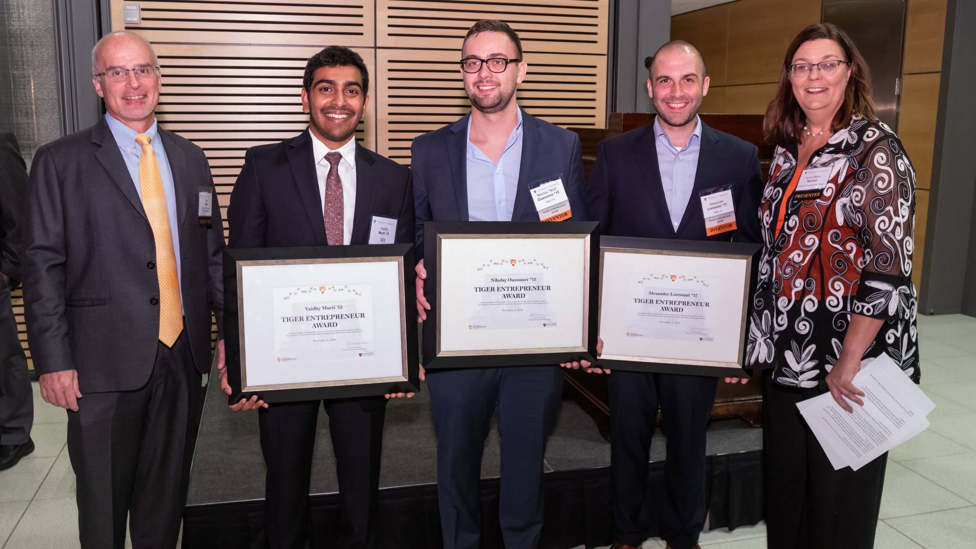Students holding award plaques