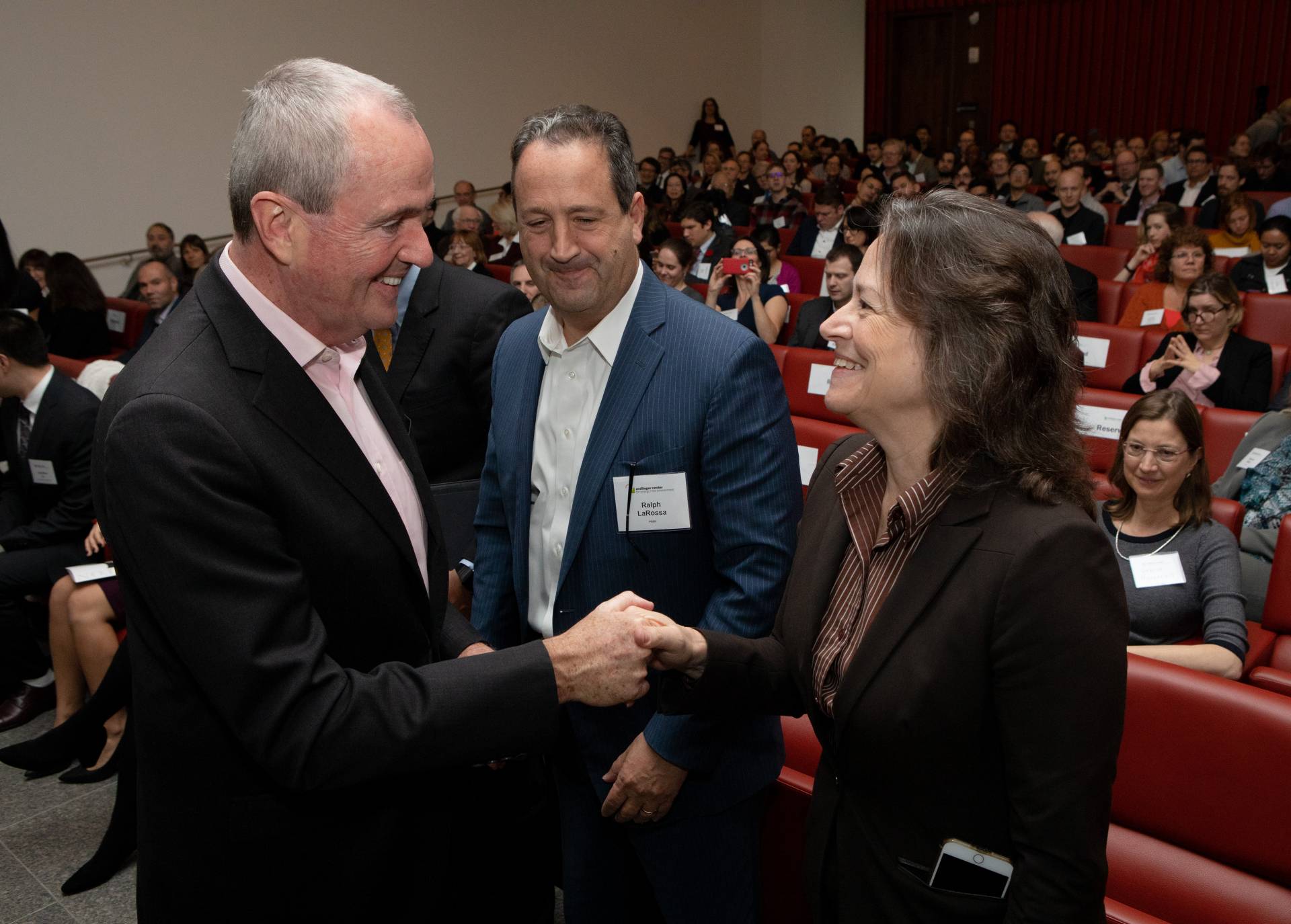 Governor Murphy and Emily Carter shake hands