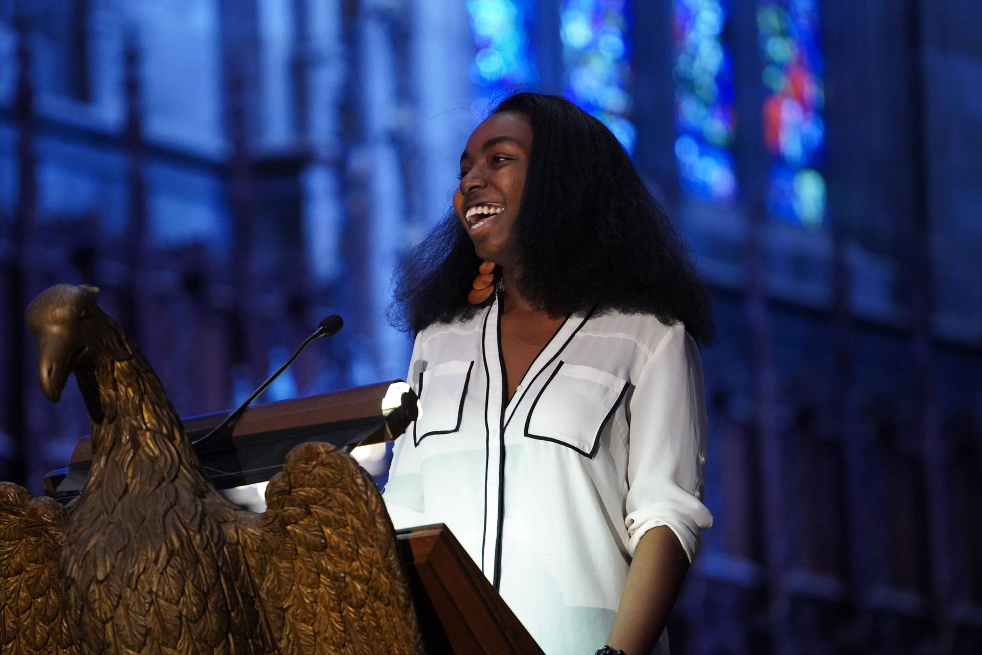 Kiki Gilber standing at podium, speaking