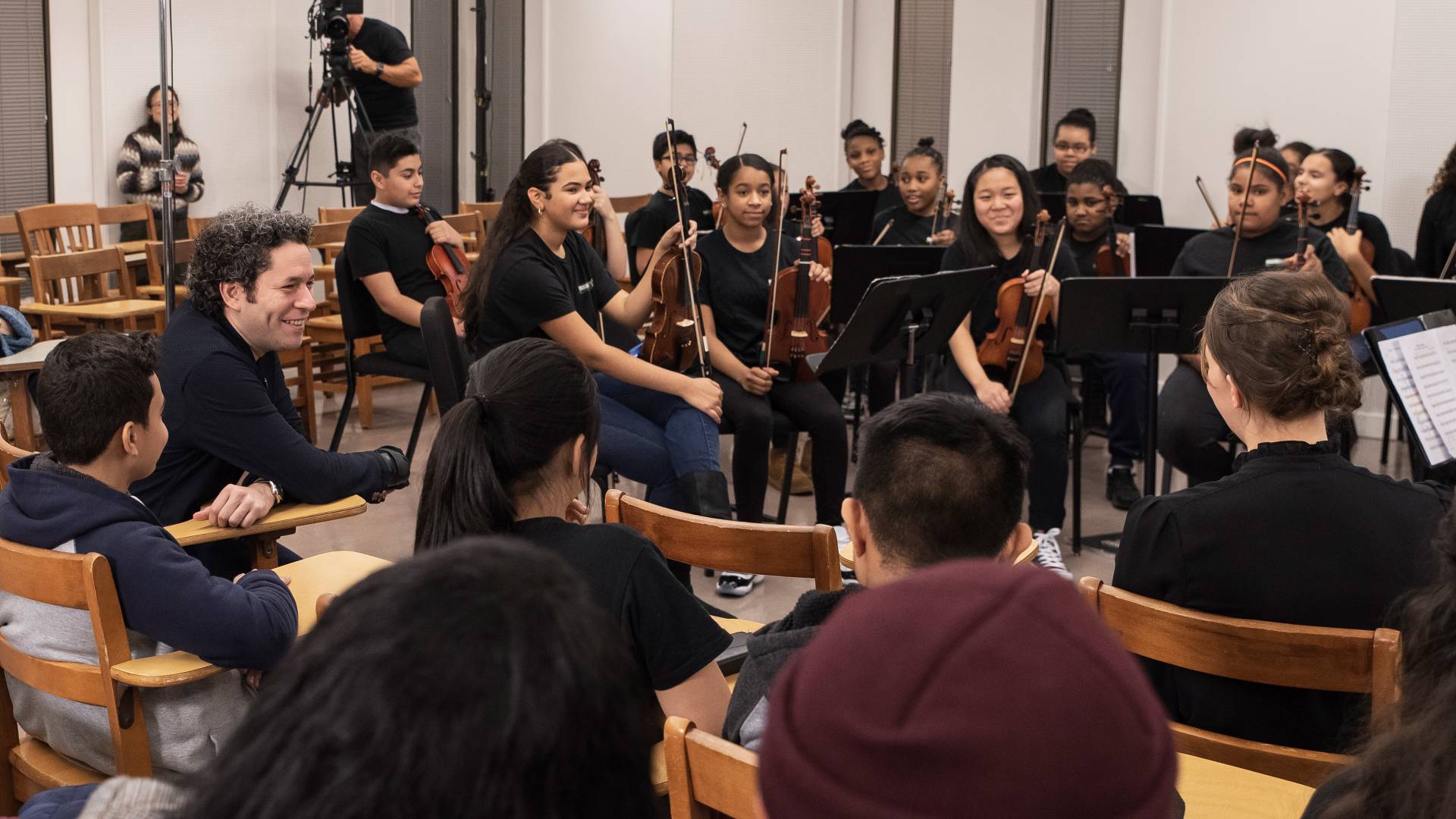 Gustavo Dudamel laughing with student orchestra